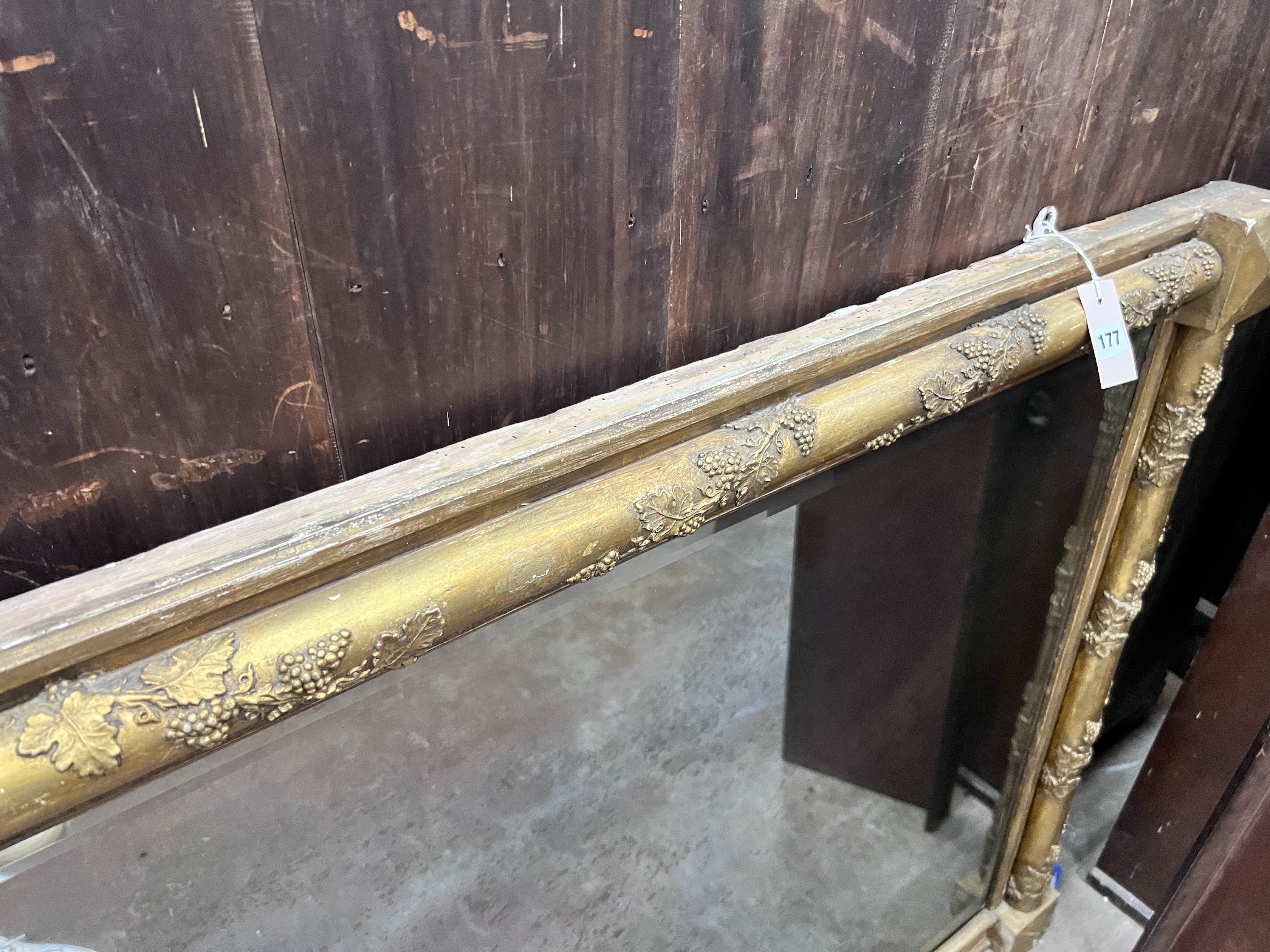 A Victorian gilt gesso and carved wood wall mirror, with vineous scroll borders, width 141cm, height 95cm *Please note the sale commences at 9am.
